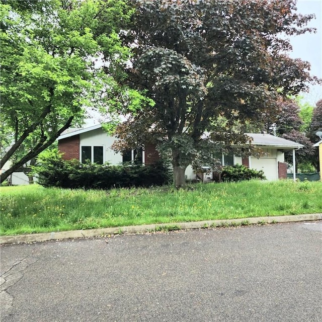 710 Standish St, Elmira-City, NY 14901 - view of front of home featuring a garage and brick siding