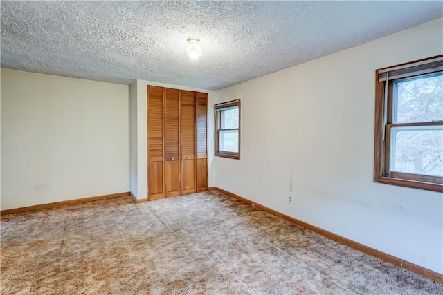 16 Welch Ave, Hamlin, NY 14470 - unfurnished bedroom featuring a closet, carpet flooring, a textured ceiling, and baseboards