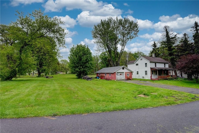 16 Welch Ave, Hamlin, NY 14470 - view of green lawn with a garage and driveway