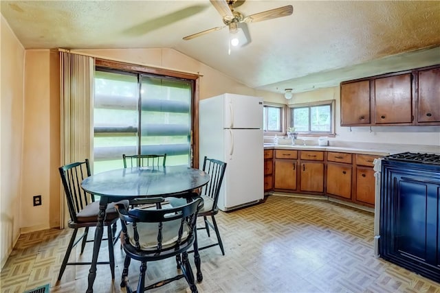 16 Welch Ave, Hamlin, NY 14470 - kitchen featuring freestanding refrigerator, vaulted ceiling, light countertops, a ceiling fan, and brown cabinets