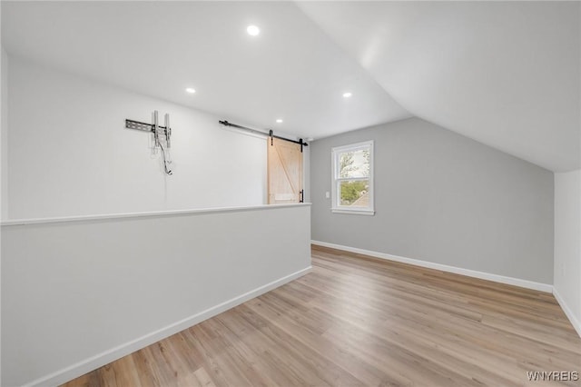 470 Windermere Blvd, Amherst, NY 14226 - additional living space with a barn door, baseboards, wood finished floors, recessed lighting, and vaulted ceiling