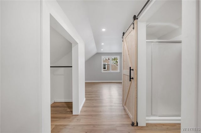 470 Windermere Blvd, Amherst, NY 14226 - hallway with a barn door, vaulted ceiling, light wood-style flooring, baseboards, and recessed lighting