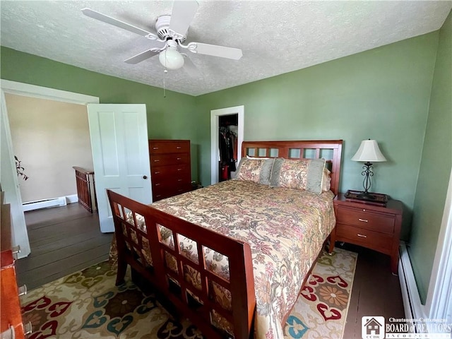 28 N Washington St, Randolph, NY 14772 - bedroom with a baseboard heating unit, hardwood / wood-style floors, a textured ceiling, a ceiling fan, and a baseboard radiator
