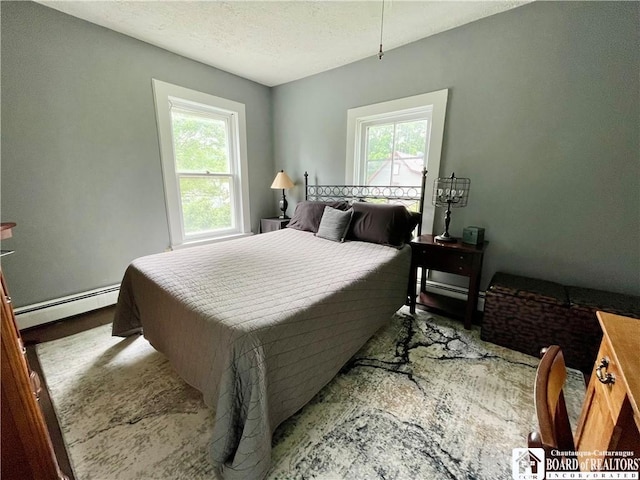 28 N Washington St, Randolph, NY 14772 - bedroom featuring baseboard heating, multiple windows, and a textured ceiling