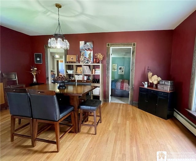 28 N Washington St, Randolph, NY 14772 - dining area featuring baseboard heating, wood finished floors, and a chandelier