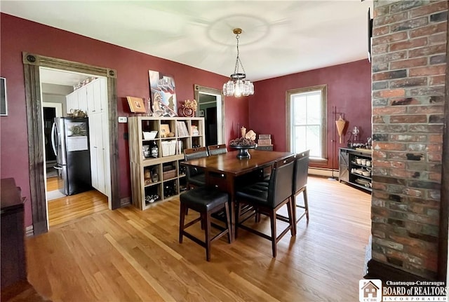 28 N Washington St, Randolph, NY 14772 - dining room featuring baseboard heating, wood finished floors, and a chandelier