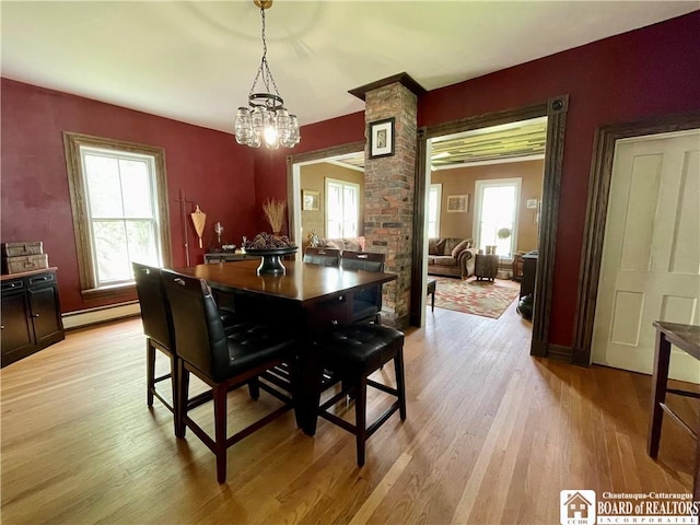 28 N Washington St, Randolph, NY 14772 - dining room featuring baseboard heating, a chandelier, light wood-type flooring, and baseboards