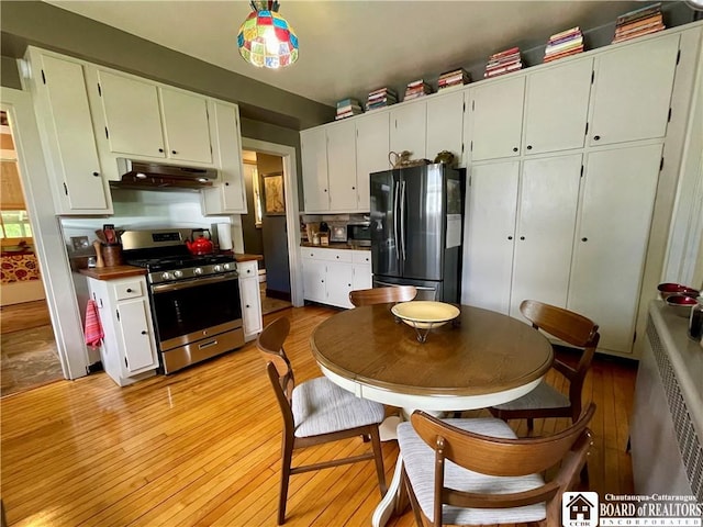 28 N Washington St, Randolph, NY 14772 - kitchen with appliances with stainless steel finishes, under cabinet range hood, light wood finished floors, and white cabinetry