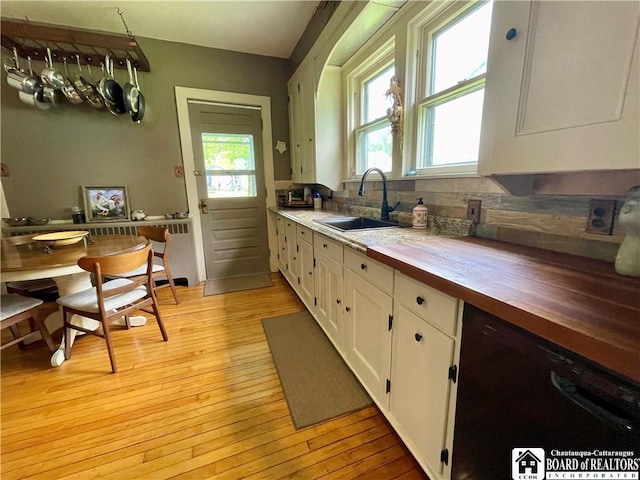 28 N Washington St, Randolph, NY 14772 - kitchen with a sink, wood counters, black dishwasher, white cabinetry, and decorative backsplash