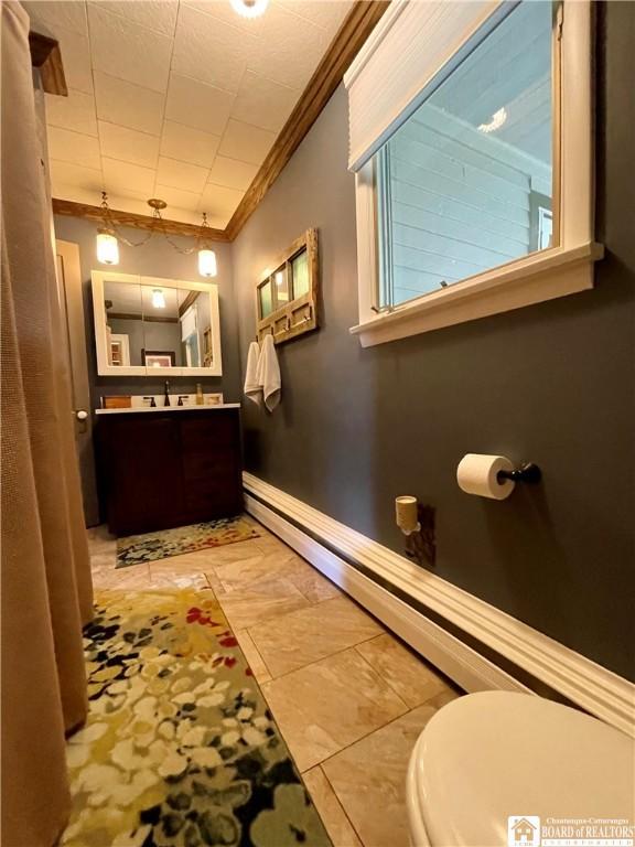 28 N Washington St, Randolph, NY 14772 - bathroom featuring crown molding, toilet, vanity, baseboards, and a baseboard radiator