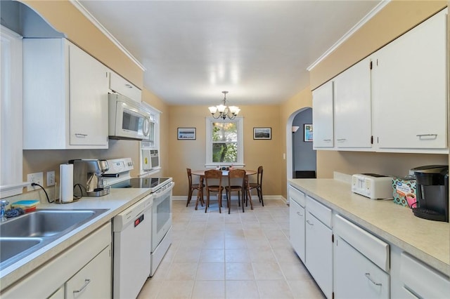 156 Rossiter Rd, Rochester, NY 14620 - kitchen with white appliances, a chandelier, light countertops, and arched walkways