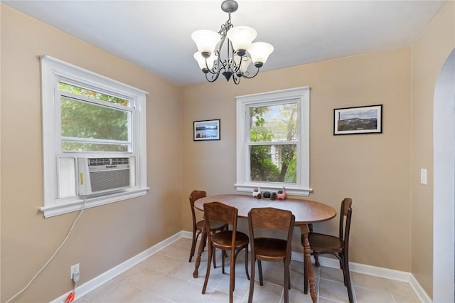 156 Rossiter Rd, Rochester, NY 14620 - dining area featuring healthy amount of natural light, a chandelier, arched walkways, and baseboards