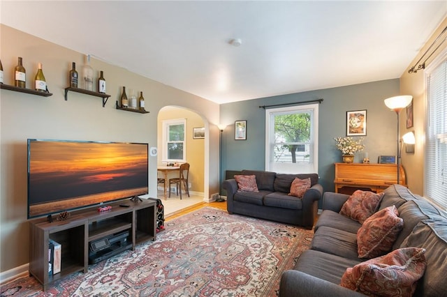 156 Rossiter Rd, Rochester, NY 14620 - living area with arched walkways, wood finished floors, and baseboards