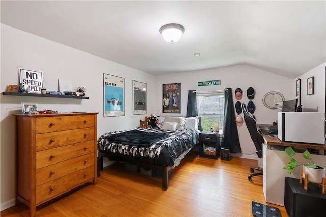 156 Rossiter Rd, Rochester, NY 14620 - bedroom with wood finished floors, vaulted ceiling, and a desk