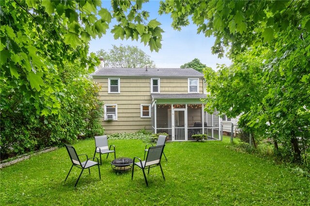 156 Rossiter Rd, Rochester, NY 14620 - rear view of house with a fire pit, a sunroom, and a chimney