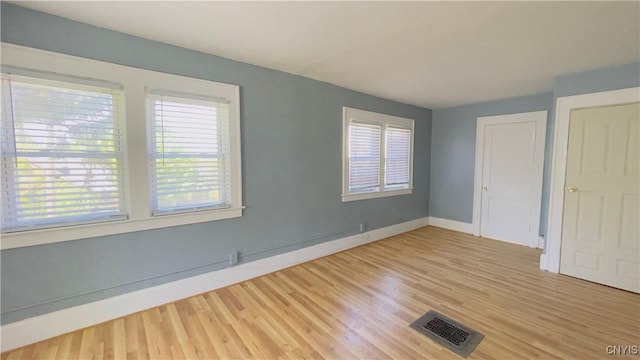 267 Fenway Dr, Syracuse, NY 13224 - unfurnished bedroom featuring multiple windows, light wood-style floors, and baseboards