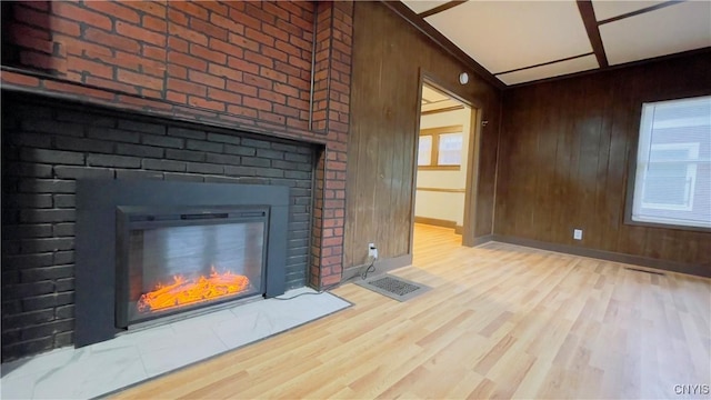 267 Fenway Dr, Syracuse, NY 13224 - unfurnished living room featuring a fireplace, wood finished floors, wooden walls, and baseboards