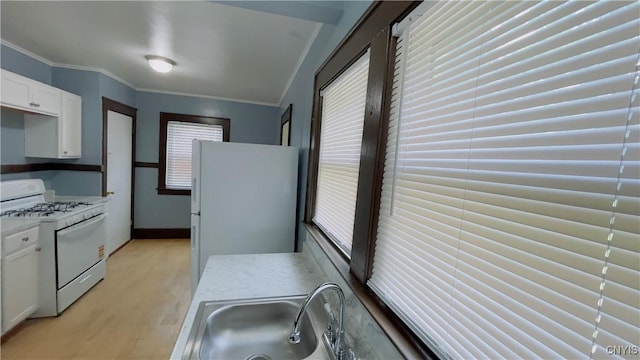 267 Fenway Dr, Syracuse, NY 13224 - kitchen with white appliances, crown molding, plenty of natural light, white cabinets, and light wood-style flooring