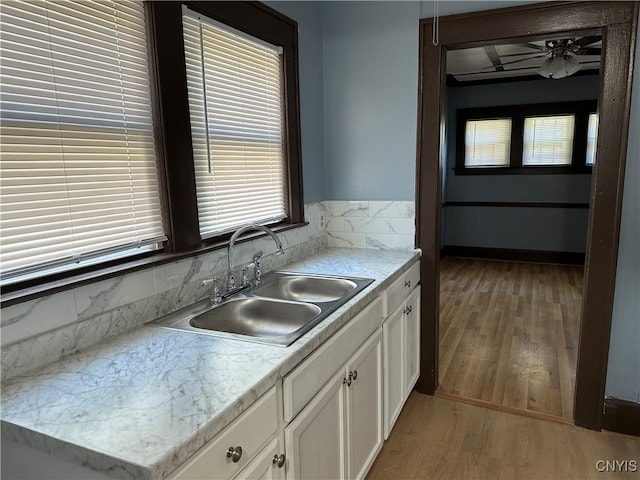 267 Fenway Dr, Syracuse, NY 13224 - kitchen featuring a sink, white cabinets, light wood finished floors, and plenty of natural light