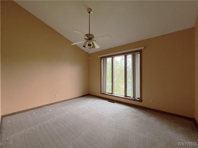 40 River Oaks Dr, Grand Island, NY 14072 - spare room featuring vaulted ceiling, light carpet, baseboards, and a ceiling fan