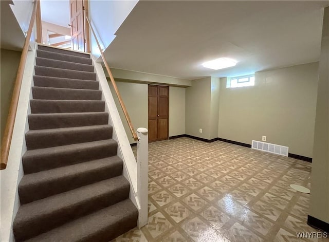 40 River Oaks Dr, Grand Island, NY 14072 - below grade area featuring stairs, light floors, and baseboards