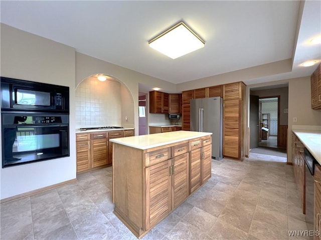 40 River Oaks Dr, Grand Island, NY 14072 - kitchen with black appliances, light countertops, a kitchen island, and brown cabinets