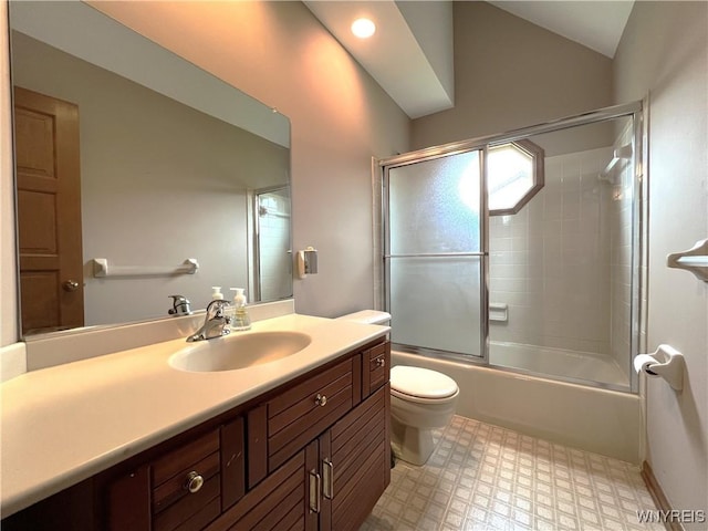 40 River Oaks Dr, Grand Island, NY 14072 - bathroom with toilet, vanity, tile patterned floors, bath / shower combo with glass door, and vaulted ceiling