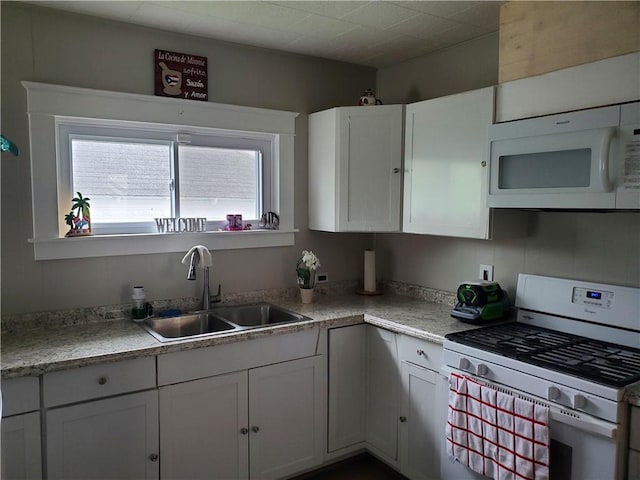 575 Lyon St, Elmira-City, NY 14904 - kitchen with white appliances, a sink, healthy amount of natural light, and white cabinets
