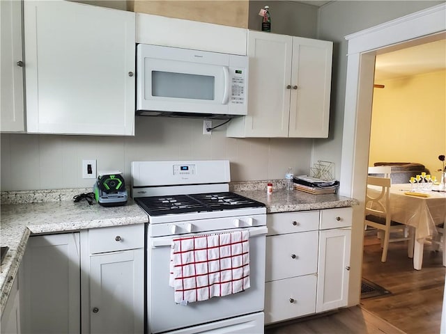 575 Lyon St, Elmira-City, NY 14904 - kitchen featuring white appliances, wood finished floors, white cabinets, and light stone countertops