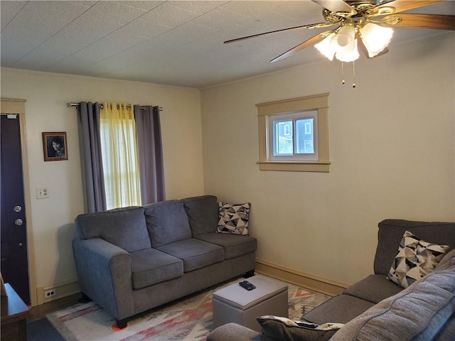 575 Lyon St, Elmira-City, NY 14904 - living room featuring a ceiling fan, baseboards, and crown molding