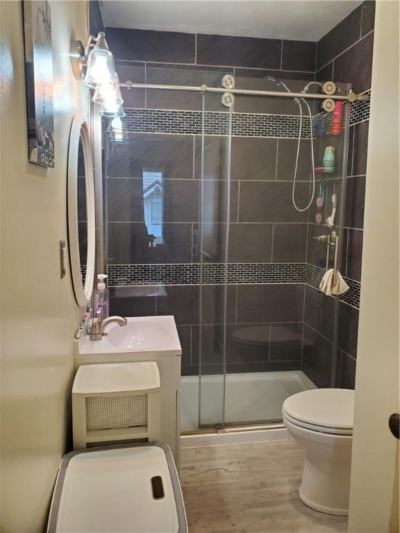 575 Lyon St, Elmira-City, NY 14904 - full bathroom with toilet, a shower stall, vanity, and wood finished floors
