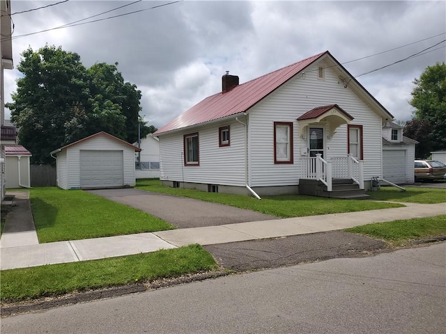 575 Lyon St, Elmira-City, NY 14904 - bungalow-style house with a garage, asphalt driveway, an outdoor structure, a metal roof, and a front yard