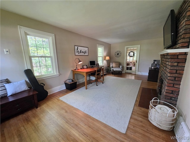 3666 S Hill Rd, Hamburg, NY 14075 - office area with wood finished floors, a brick fireplace, and baseboards