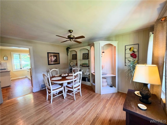3666 S Hill Rd, Hamburg, NY 14075 - dining room featuring wood finished floors, ceiling fan, and crown molding