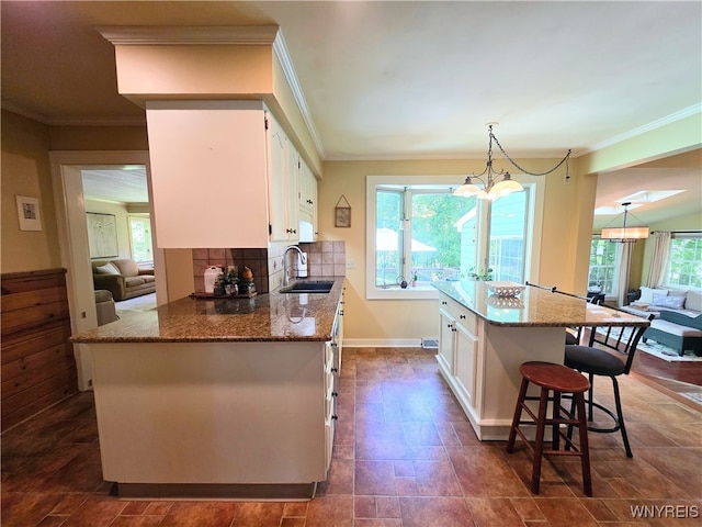 3666 S Hill Rd, Hamburg, NY 14075 - kitchen with a sink, white cabinets, healthy amount of natural light, and crown molding
