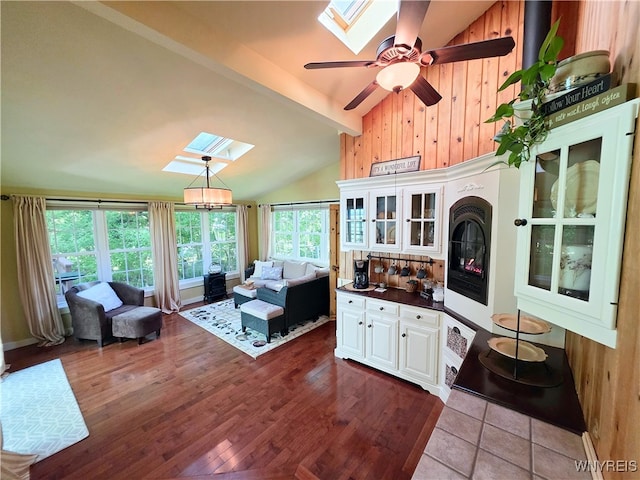3666 S Hill Rd, Hamburg, NY 14075 - living area with a skylight, wooden walls, wood finished floors, and a ceiling fan