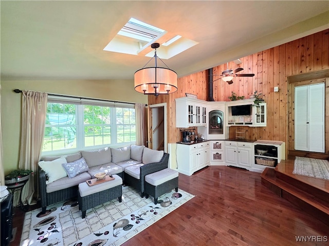 3666 S Hill Rd, Hamburg, NY 14075 - living room featuring a skylight, dark wood-type flooring, wood walls, lofted ceiling, and a chandelier