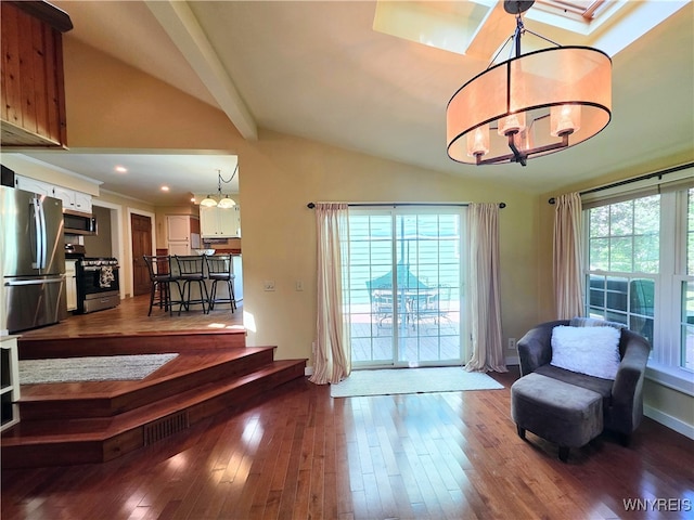 3666 S Hill Rd, Hamburg, NY 14075 - doorway featuring a chandelier, vaulted ceiling, dark wood finished floors, and a skylight