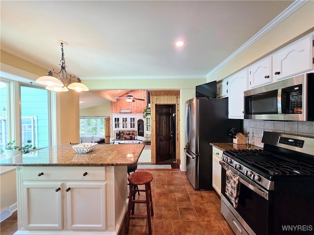 3666 S Hill Rd, Hamburg, NY 14075 - kitchen with stainless steel appliances, crown molding, white cabinetry, light stone countertops, and a kitchen island