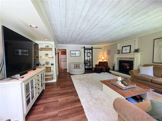 3666 S Hill Rd, Hamburg, NY 14075 - living area with dark wood finished floors, a barn door, a lit fireplace, and wooden ceiling