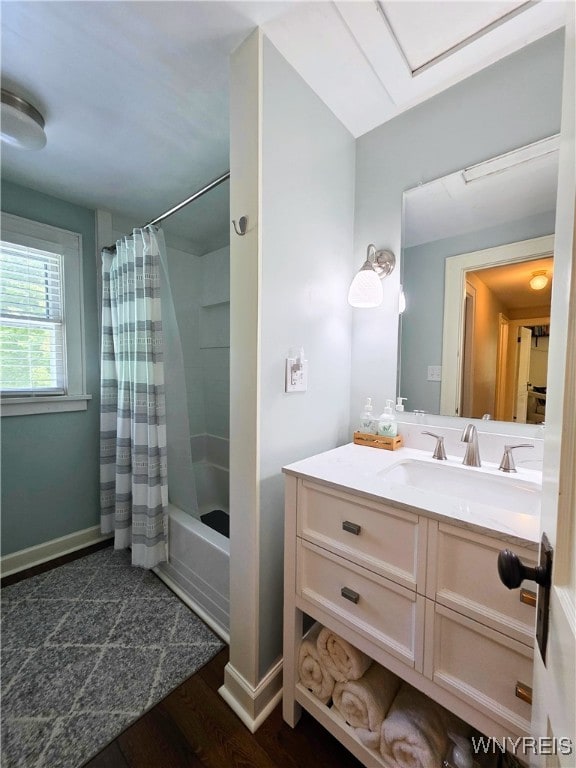 3666 S Hill Rd, Hamburg, NY 14075 - bathroom featuring vanity, shower / bath combination with curtain, wood finished floors, and baseboards