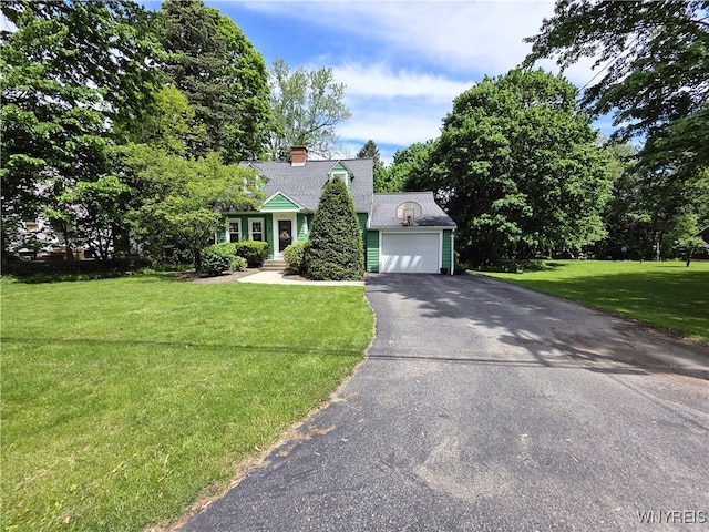 3666 S Hill Rd, Hamburg, NY 14075 - new england style home featuring asphalt driveway, a front lawn, an attached garage, and a chimney