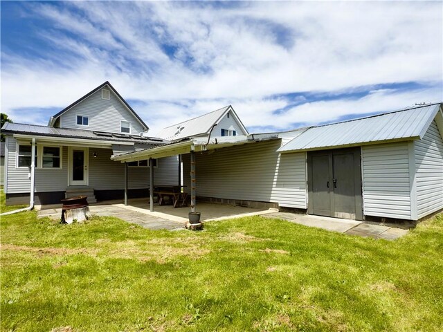 113 1st St, Shinglehouse, PA 16748 - rear view of property featuring a lawn, metal roof, entry steps, and a patio