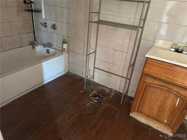 1306 E Lovejoy St, Buffalo, NY 14206 - full bathroom with hardwood / wood-style floors, tile walls, vanity, and shower / bath combination