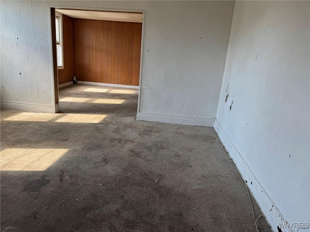 1306 E Lovejoy St, Buffalo, NY 14206 - carpeted spare room featuring wood walls and baseboards