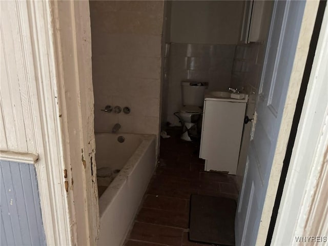1306 E Lovejoy St, Buffalo, NY 14206 - bathroom featuring vanity, toilet, tile walls, and shower / washtub combination