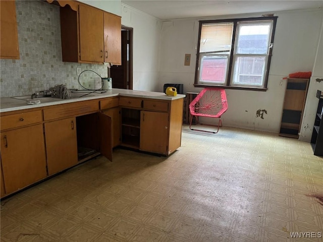 1306 E Lovejoy St, Buffalo, NY 14206 - kitchen with light countertops, light flooring, a peninsula, and decorative backsplash