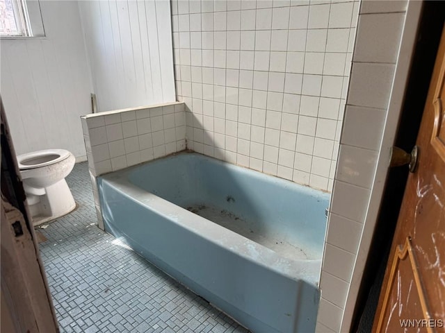 1306 E Lovejoy St, Buffalo, NY 14206 - bathroom with toilet, a garden tub, and tile patterned floors