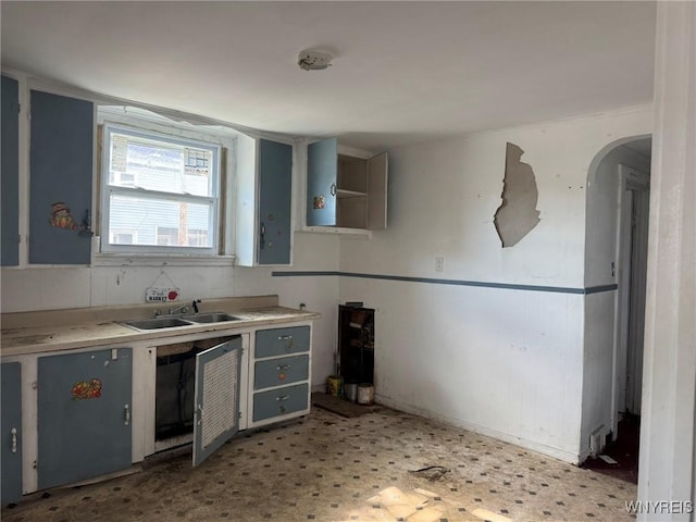1306 E Lovejoy St, Buffalo, NY 14206 - kitchen featuring a sink, light flooring, light countertops, and arched walkways