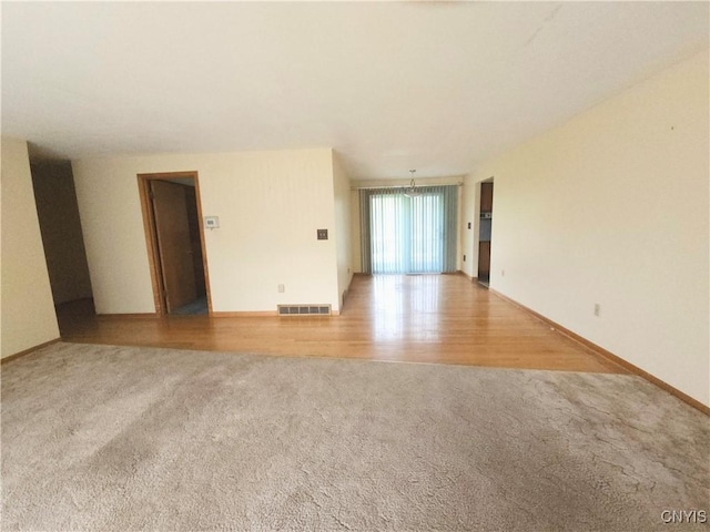 7742 Davis Rd S, Clay, NY 13212 - unfurnished room featuring light colored carpet, baseboards, and light wood-style floors